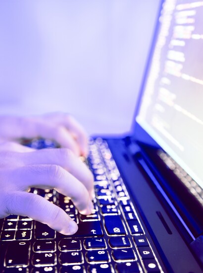 student looking at programming code on a computer