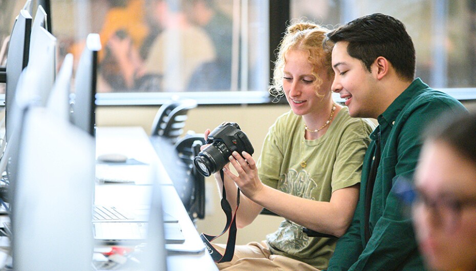students looking at a camera in a computer lab