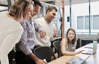 students standing around a computer