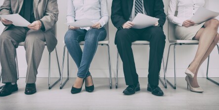 job applicants waiting for interview with resumes