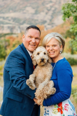 Michael Grooms with his wife. Both holding their dog between them.