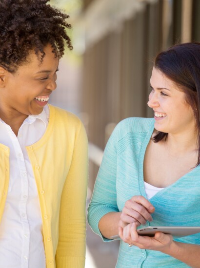 Two women smiling together outside