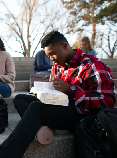 student studying the scriptures outside