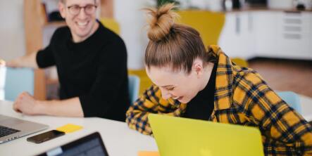 students laughing at table