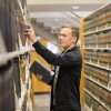 student in library stacks