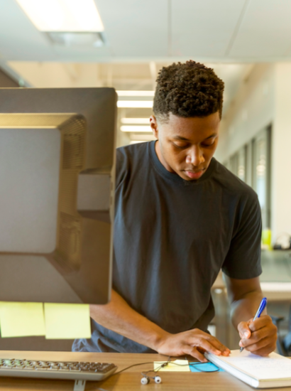 Male student writing on notepad