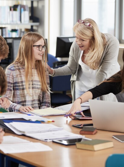 Students being helped by faculty