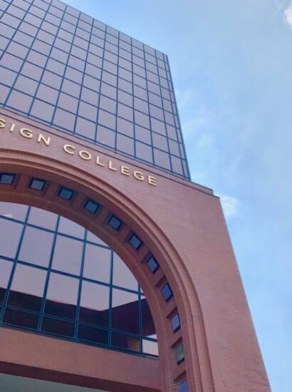 students outside walking building