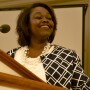 Women speaking at at pulpit.