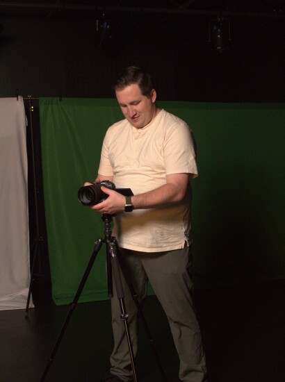 Student using digital content studio equipment for school project