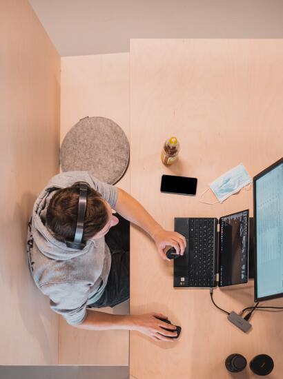 Student working on computer from above
