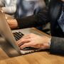 Typing on a laptop