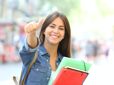 smiling female student giving a thumbs up