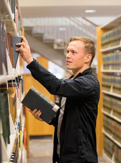 A student checks out a book at the bookstore