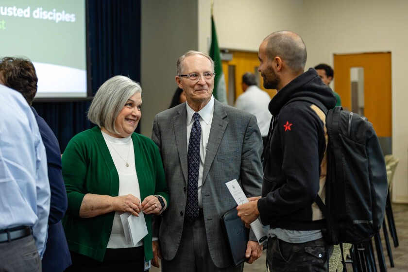 President & Sister Kusch with guest at open house