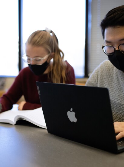 Students with masks studying in library
