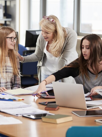 Students being helped by faculty