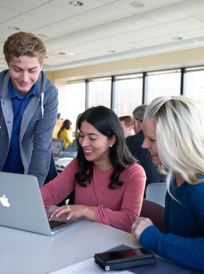 students in class working on laptop