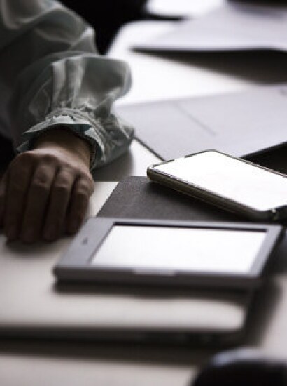 Student studying using a tablet and computer.