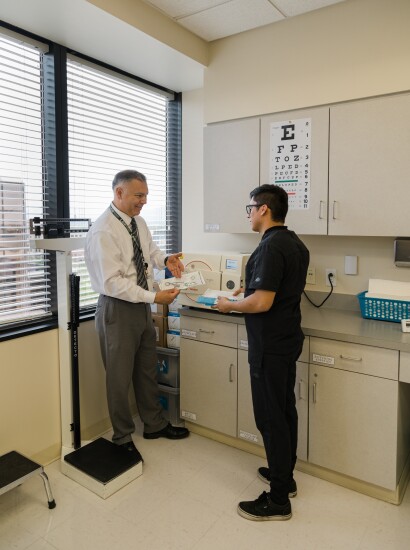 Male medical assistant learning in clinic