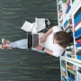 female student on laptop in library